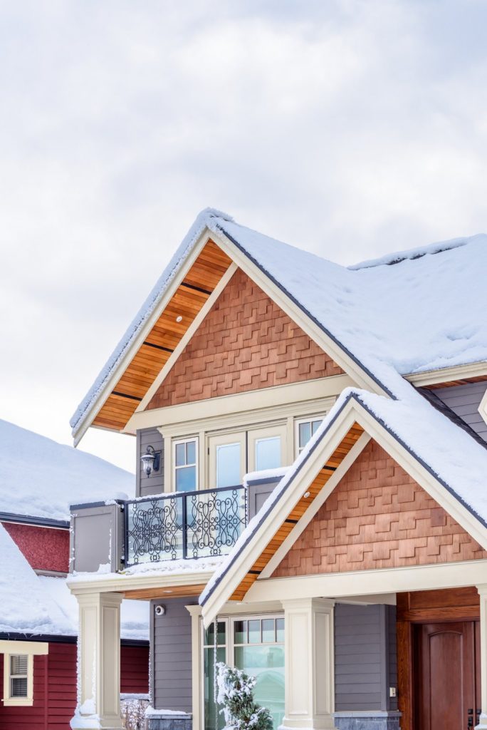 Aurora Modern Craftsman Home Exterior with Snow Covered Roof and Balcony.jpg