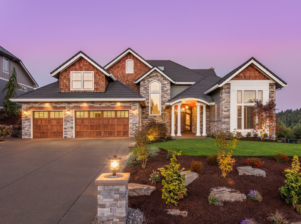New Home Luxury Craftsman Estate with Cedar Shingles and Stone Masonry at Twilight.jpg