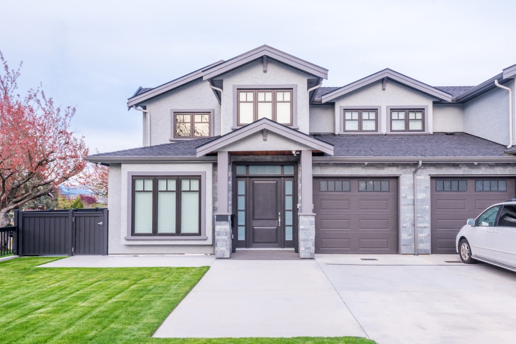 New Home Modern Grey Stucco Design with Stone Accents and Double Garage.jpg
