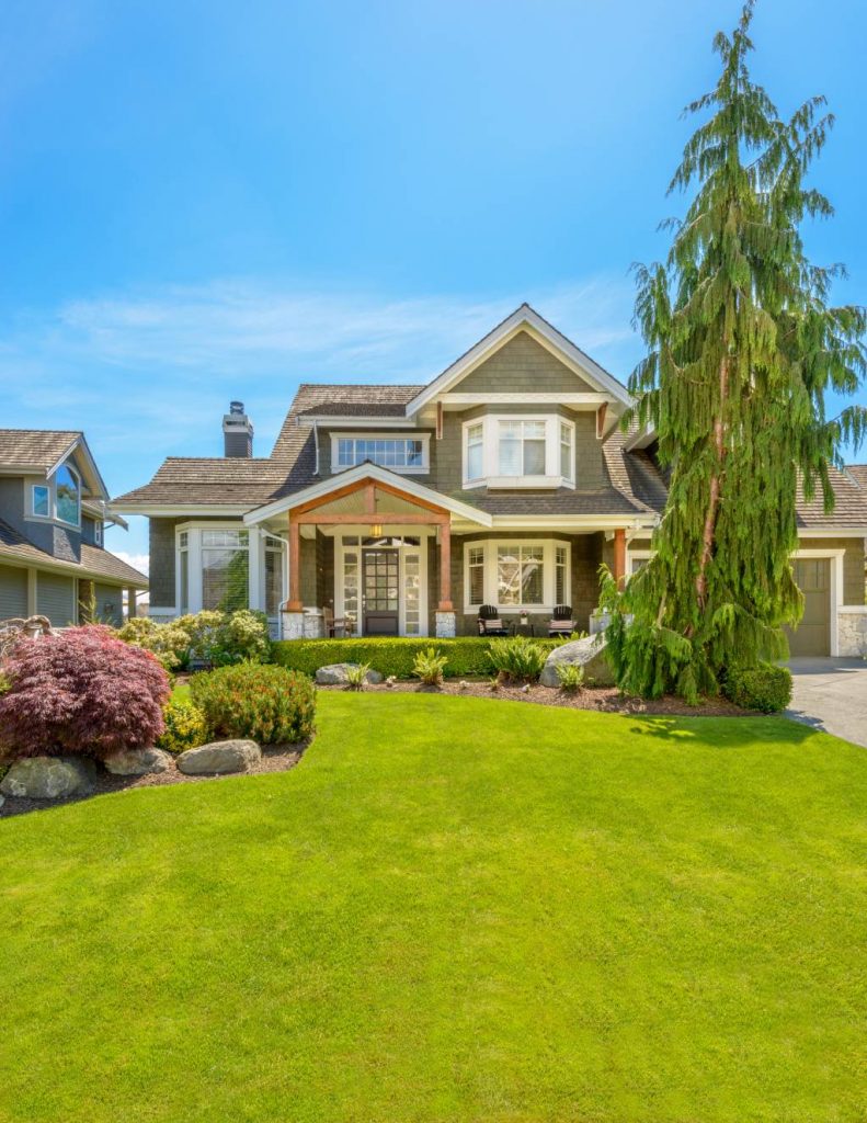 Volga Luxury Executive Home with Beige Stone and Manicured Landscaping.jpg